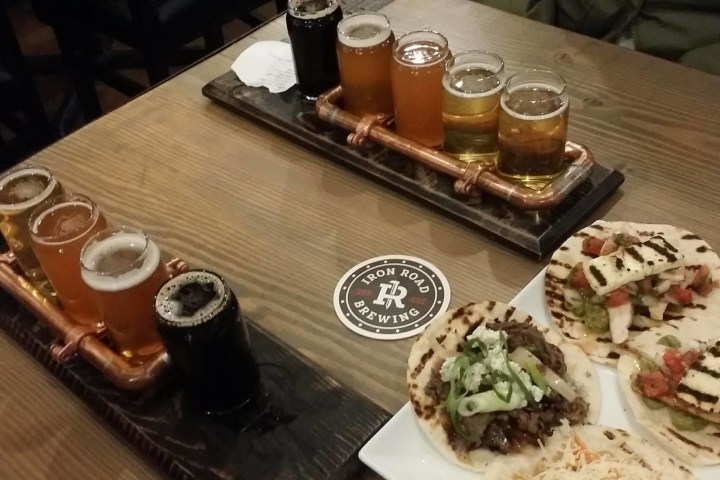 a wooden table topped with plates of food